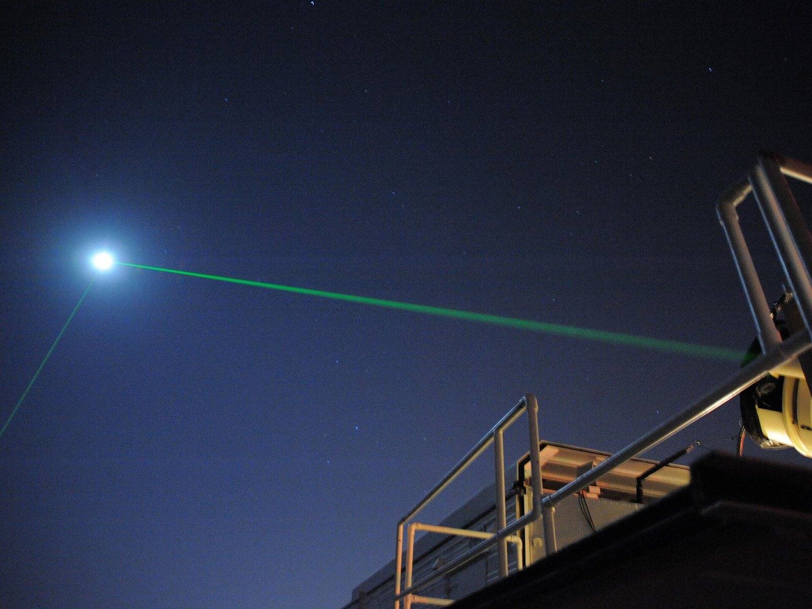 A green laser beam fired toward the Moon from NASA's Goddard laser ranging facility
