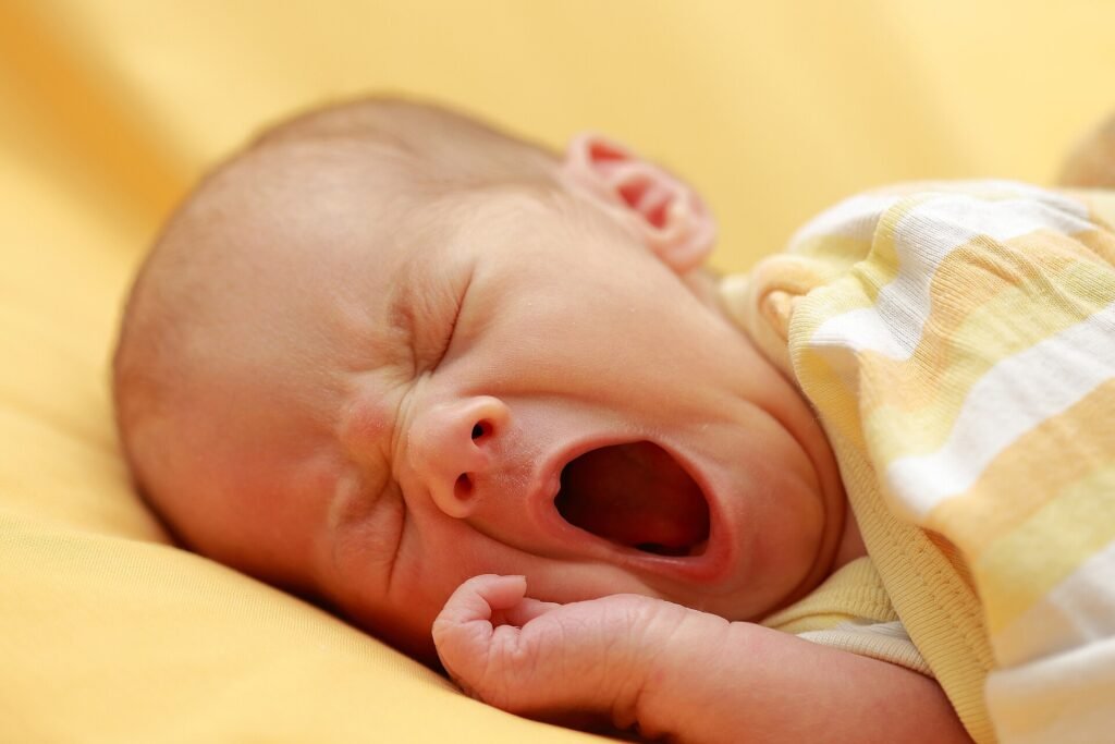 A newborn baby yawning