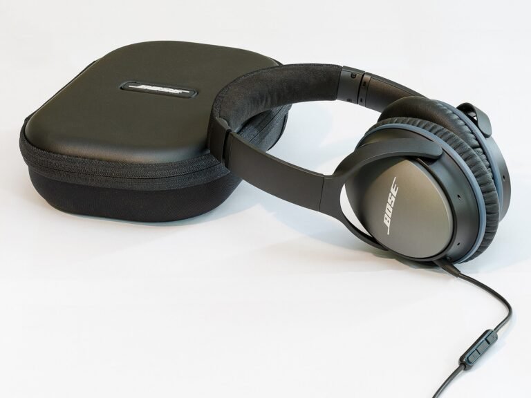 Noise-cancelling headphones beside their carrying case